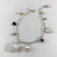 Pulseira corrente elos ovais prata 925 polida (clara), com pingentes em pedras quartzo rosa, pérola lilás, granada, quartzo cereja e rodocrosita. Comprimento: regulagem entre 15cm e 18cm. Para outras medidas entre em contato. Embalagem em envelope de tecido, com cartão postal Amor Maior. Esta é uma joia de prata 925 produzida com uma liga conhecida internacionalmente com STERLING SILVER – 925, o que significa que ela é constituída de 92,5% de prata pura, garantindo a qualidade do material utilizado. Por se 